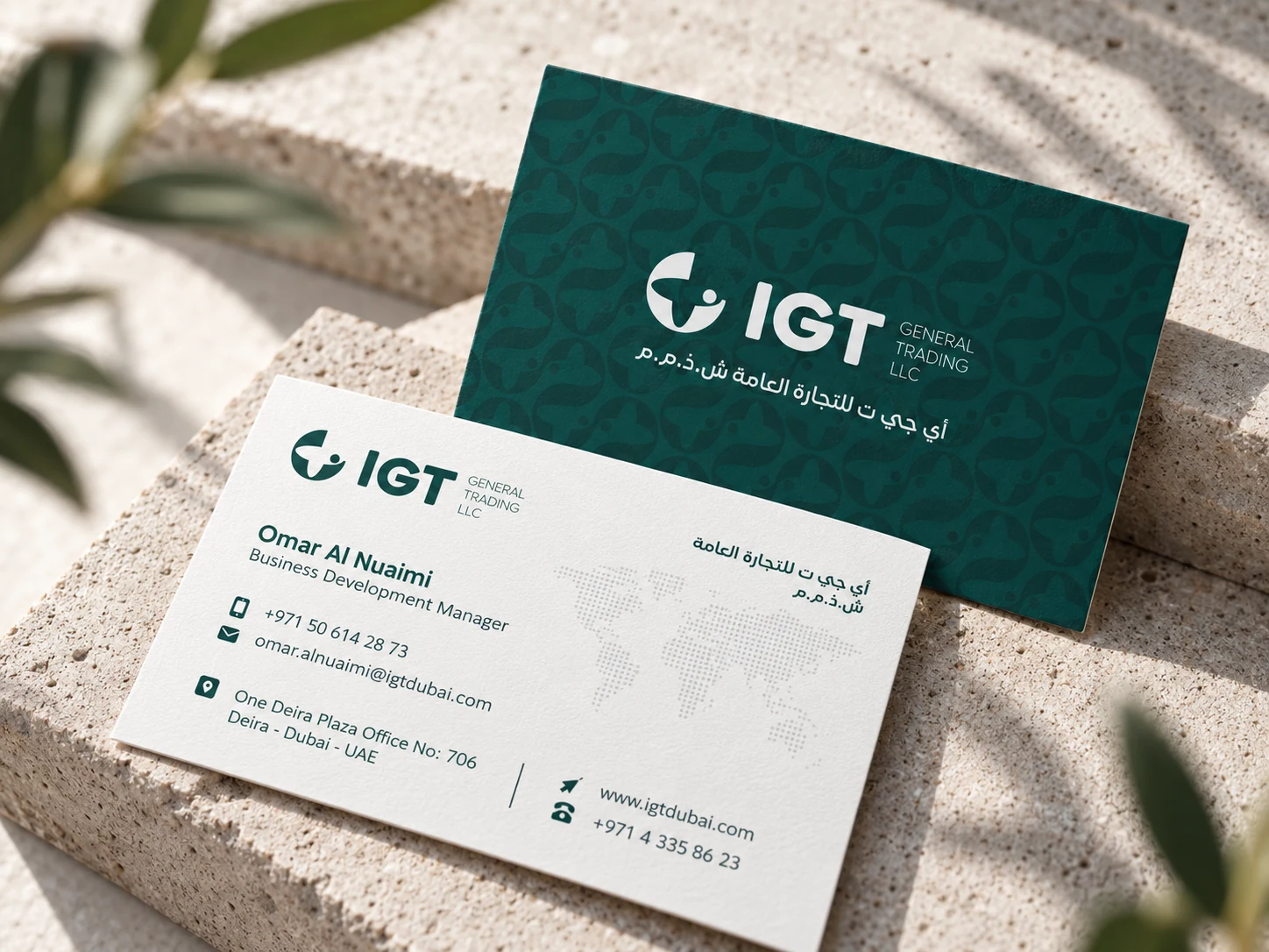 IGT business cards on a stone surface